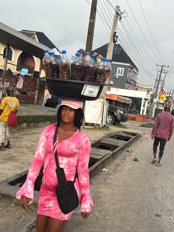 Morning foot traffic on a paved street in Ado, Nigeria