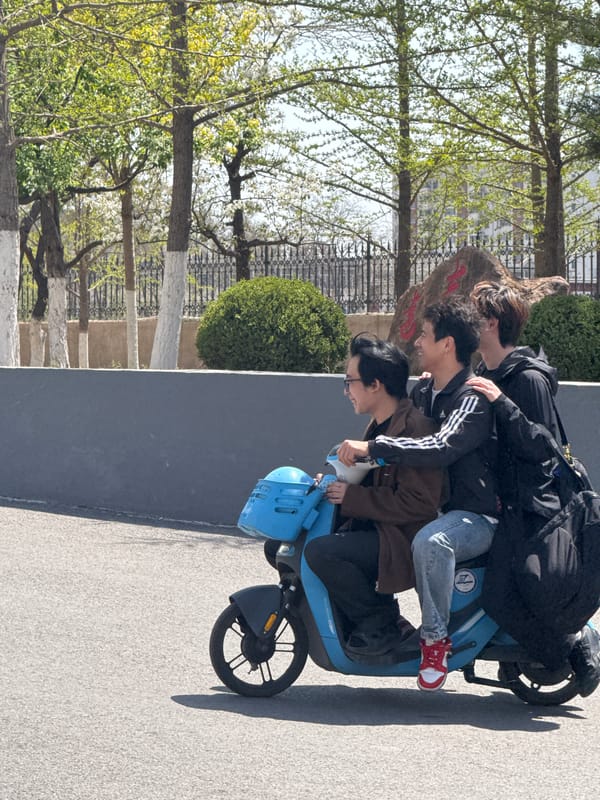 Three riders share blue electric scooter in Zhongtun