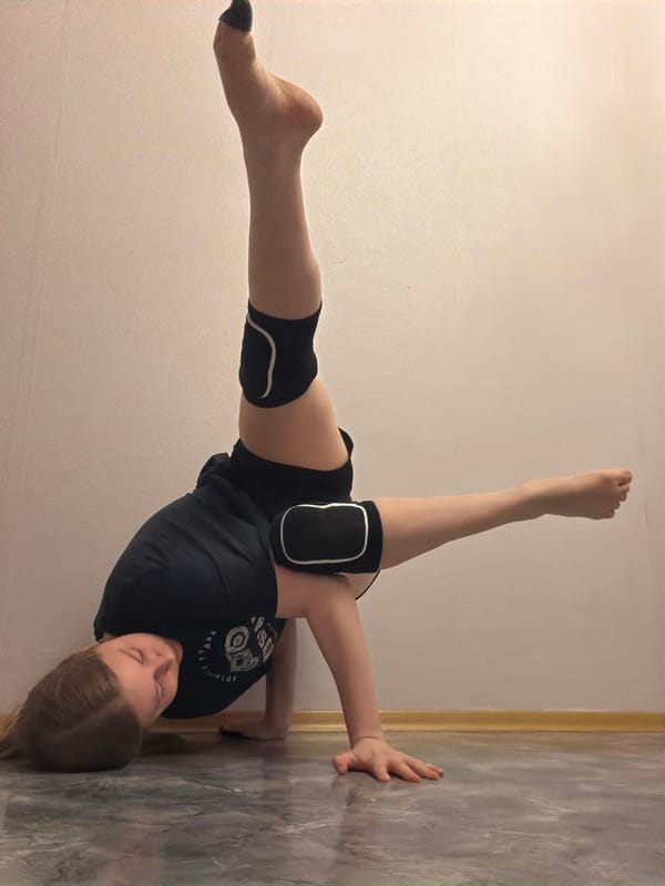 Gymnast practices wall handstands and backbends in Perm apartment