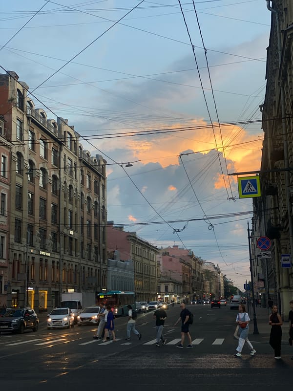 Saint Petersburg street glows under a summer evening sunset.