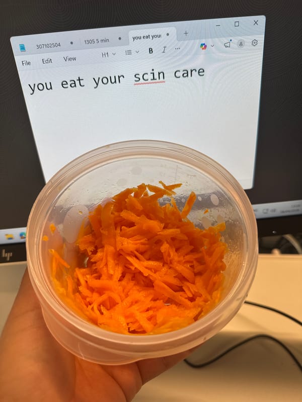 Person holds shredded carrots near computer screen in Alicante