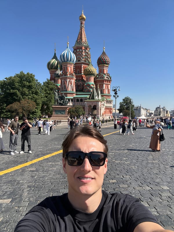 Tourist photographs Red Square landmarks on sunny afternoon