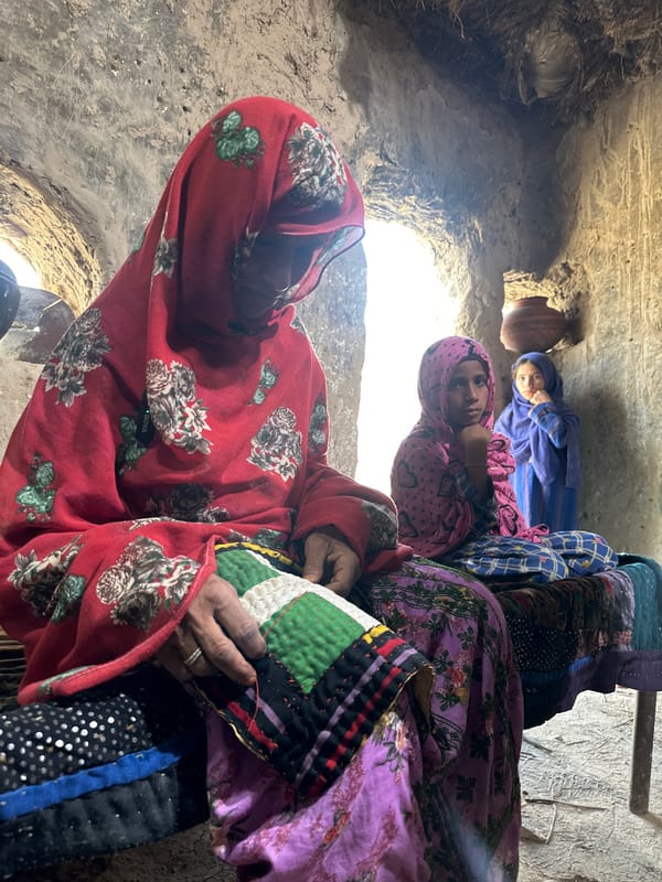 Three women gather in traditional dwelling in Quetta