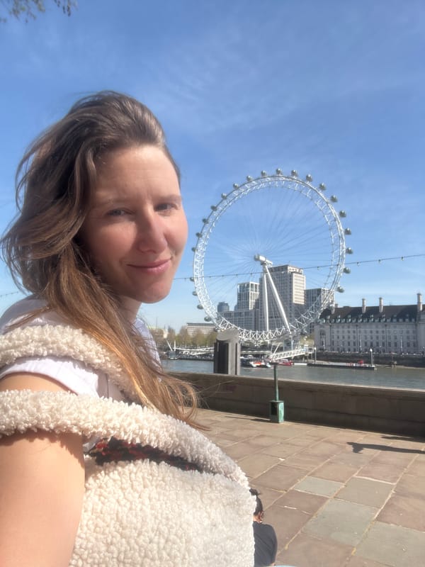 Woman takes selfies at London Eye on clear day