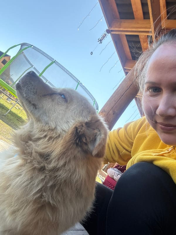 Woman photographs with dog in rural Russian town