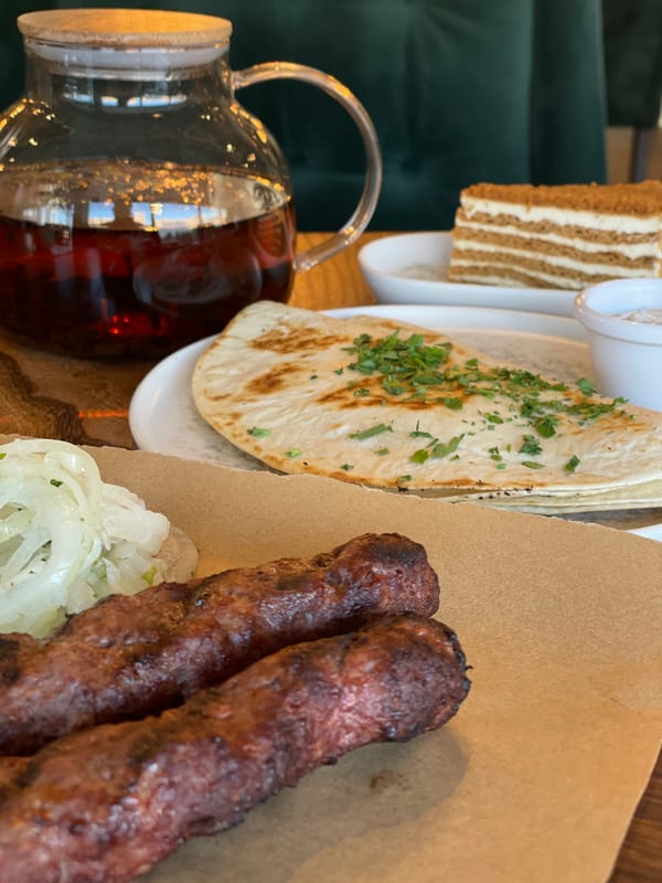 Restaurant meal with grilled skewers and cake in Kazan