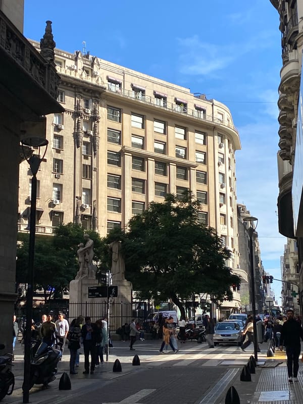 Woman cycles across Buenos Aires crosswalk on folding bike