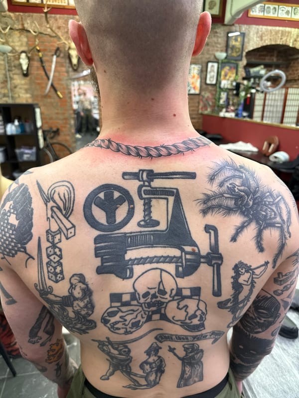 Heavily tattooed man photographed at Moscow tattoo parlor