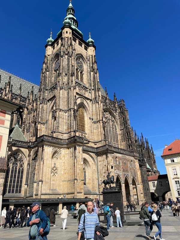 Prague street scene captured with historic plague column