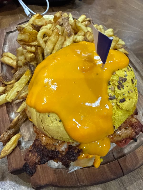 Burger with yellow sauce photographed in Paris