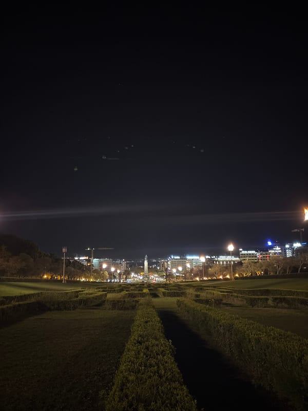 Nighttime photography captures illuminated Lisbon landmarks and streetscapes