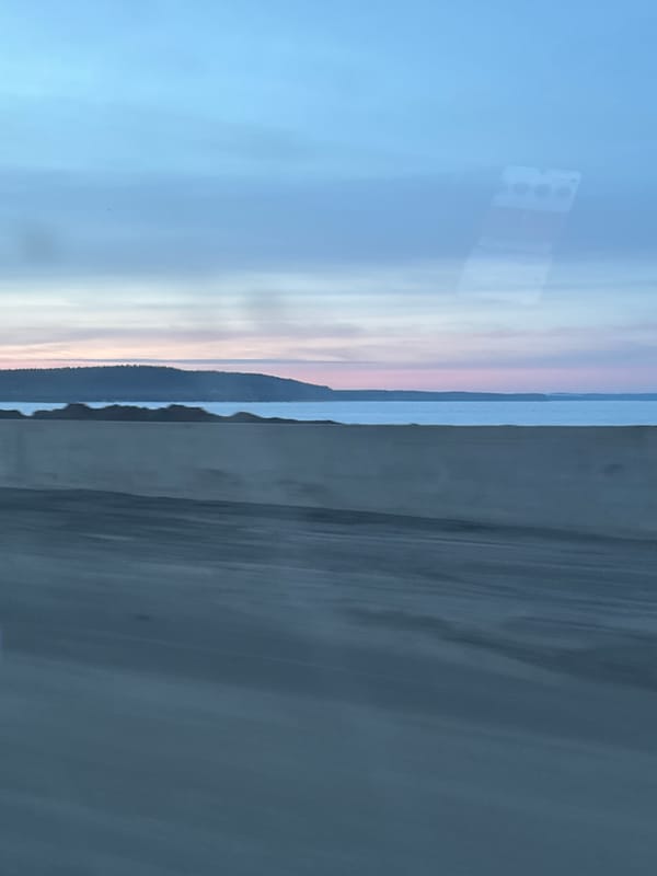 Vehicle journey past Votkinsk Reservoir captured during twilight in Chaikovsky