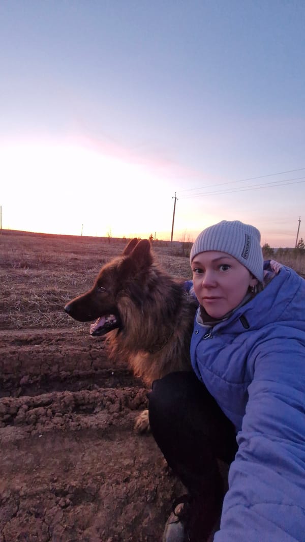 Woman poses with large dog during sunset in Otchor