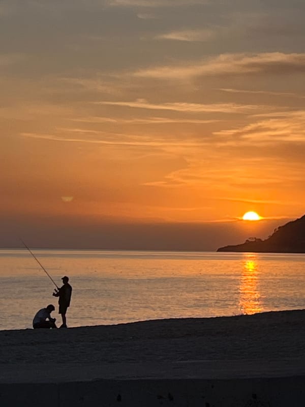 Sunset watchers gather on Alanya beach during golden hour