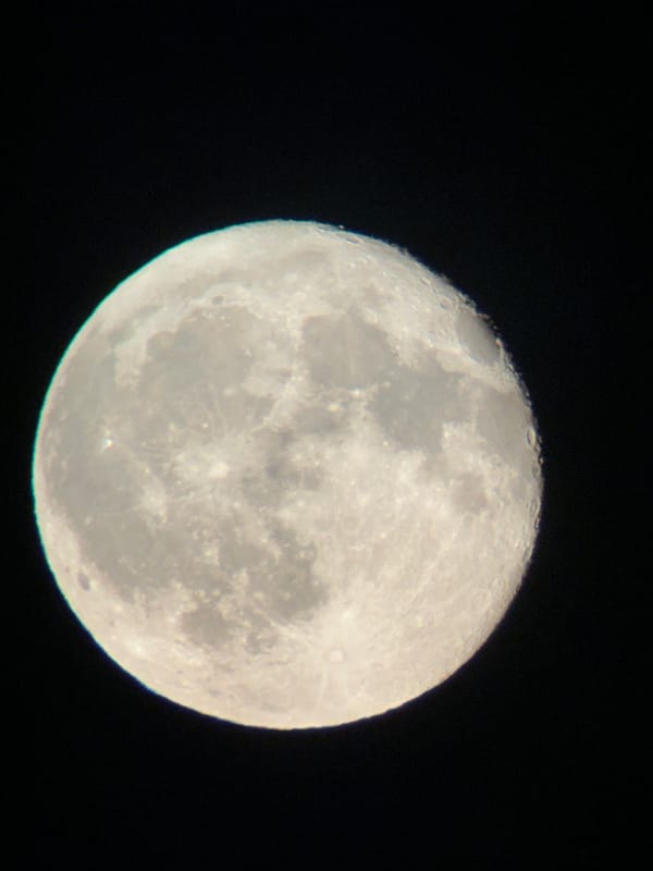 Moon photographed two ways over Târgu Neamț on a summer evening