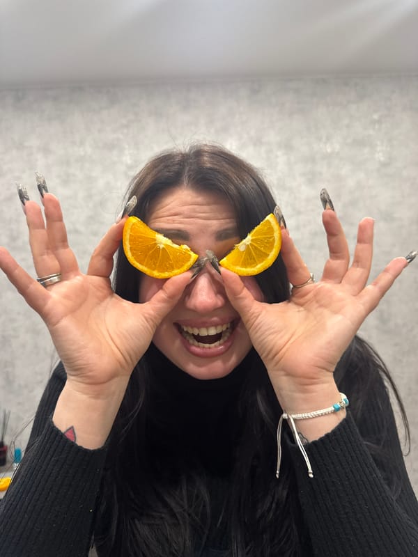 Person poses with orange slices during casual photo session