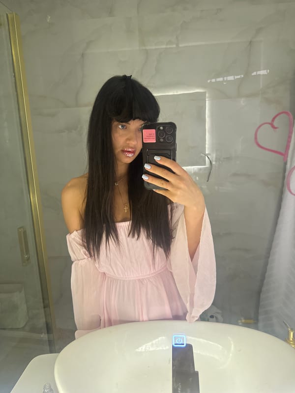 Woman takes mirror selfie in light pink outfit, Moscow