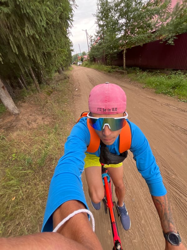 Cycling a tree-lined dirt road in Chaikovsky, Russia