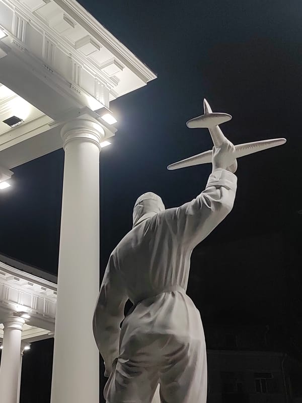 Batumi's pilot statue and lit streets on a summer night