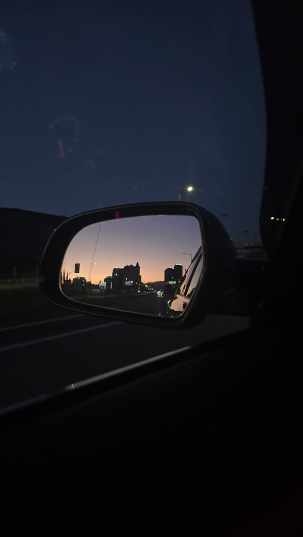 Evening cityscape reflected in car mirror, Sofia Bulgaria