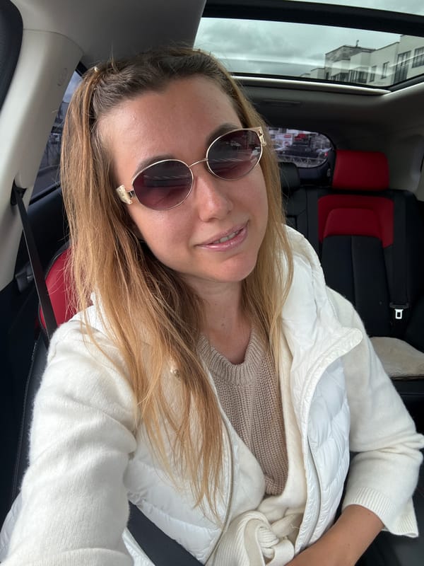 Woman takes selfies in passenger seat during car ride