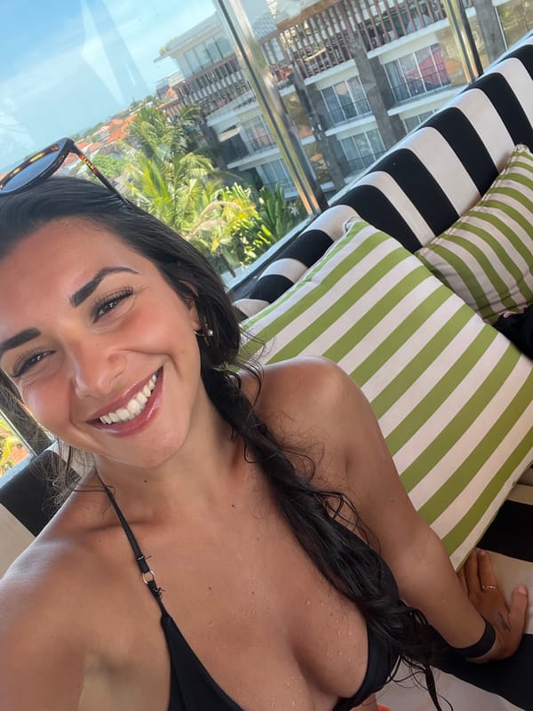 Woman enjoys morning relaxation on beach lounger in Kuta