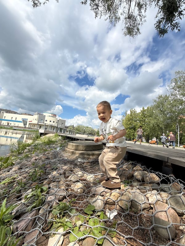 Woman and toddler enjoy morning waterfront visit in Rusanovo