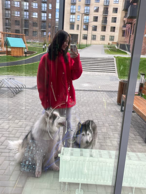 Woman photographs herself with two dogs in Russian building