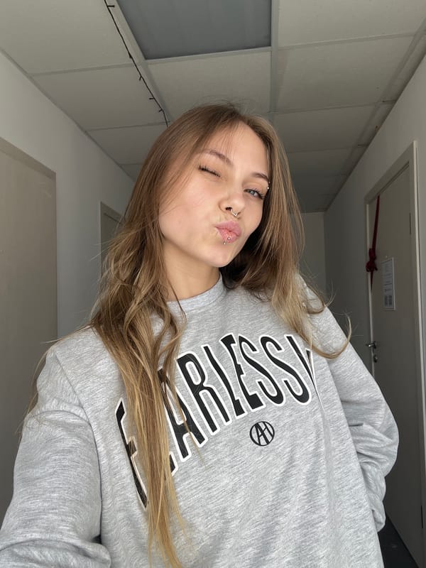 Woman takes selfies in grey sweatshirt in Фоки, Russia