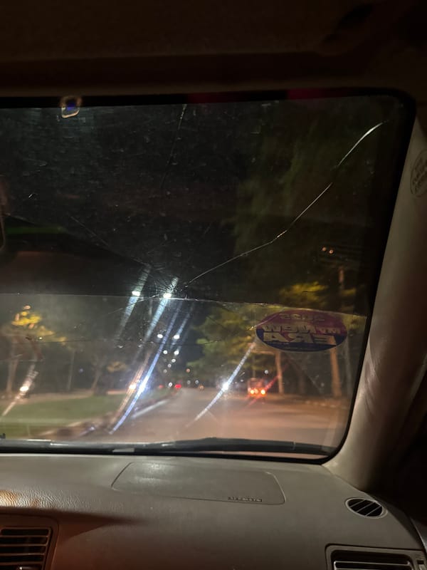 Vehicle windshield cracked during evening hours in Abuja