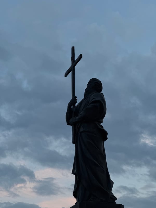 Holy Trinity Church and cross-bearing statue photographed in Bataysk