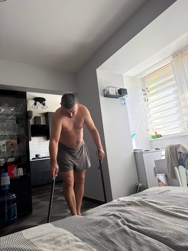 Lazy Saturday morning at home, kid on the couch, adult tidying up