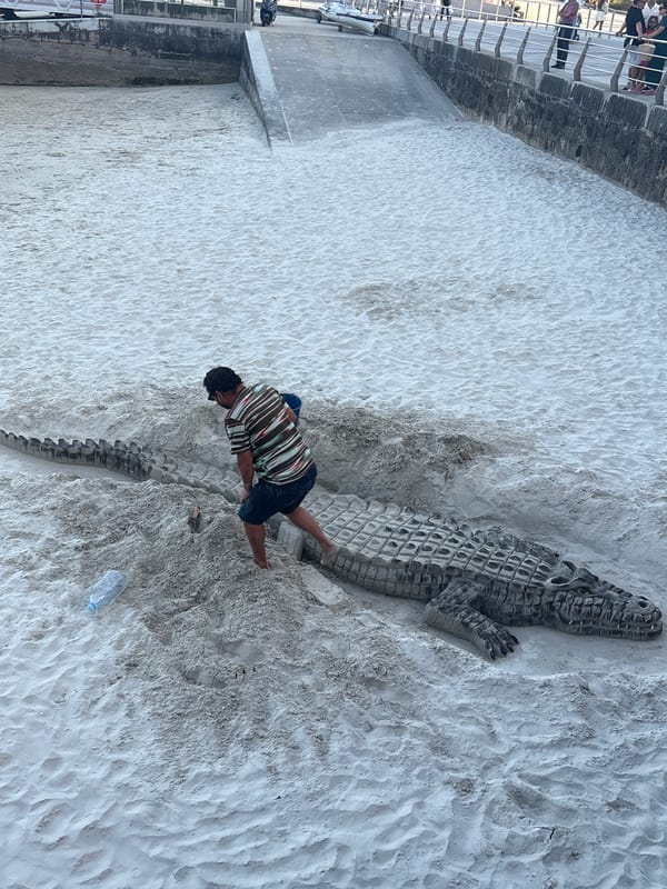 Elaborate sand crocodile sculpted on a Sanxenxo beach