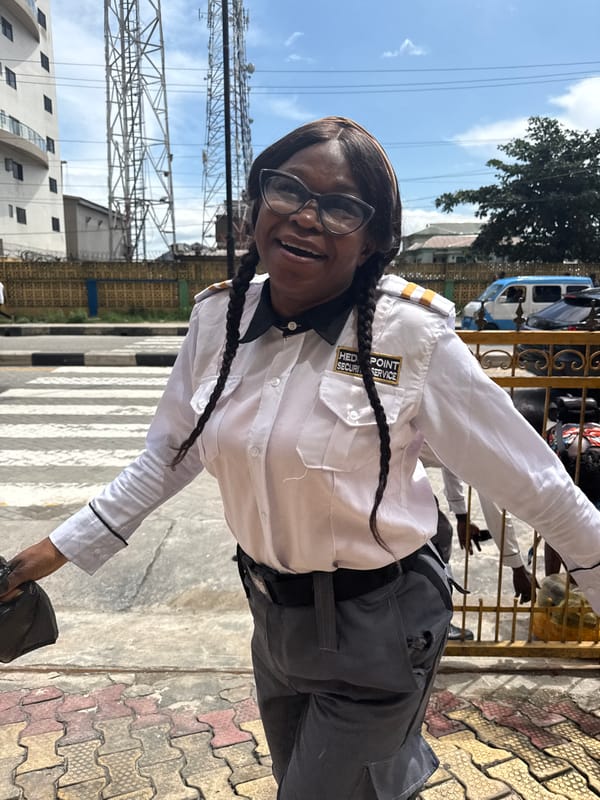 Security presence and a shuttered storefront in Itirin, Lagos