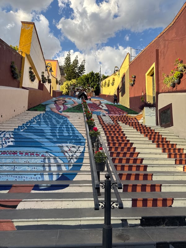 Street mural of woman in blue adorns stairs in Atlixco