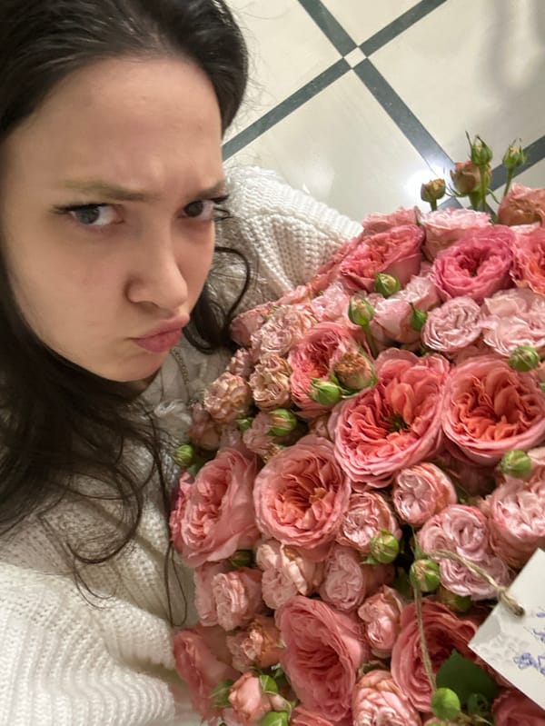 Woman poses with roses, stuffed animal in Yerevan morning