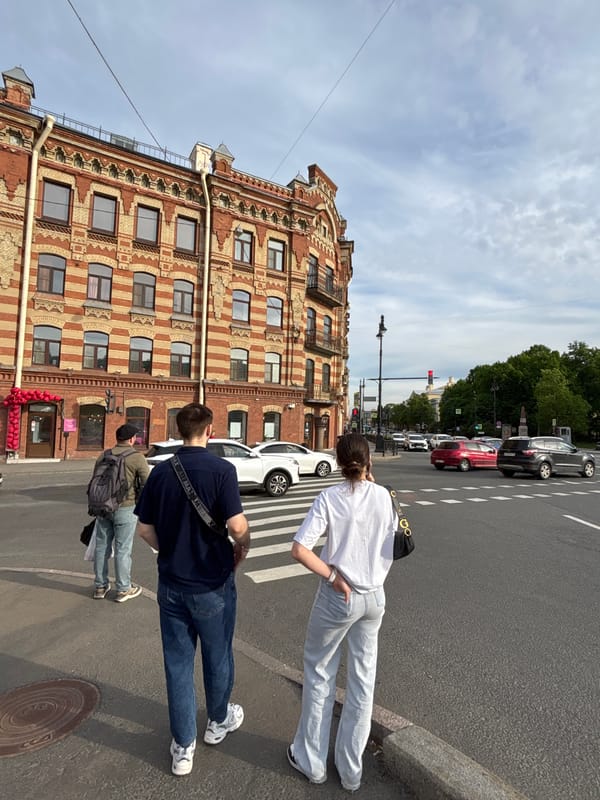 Tourists and pedestrians explore central Saint Petersburg on sunny afternoon