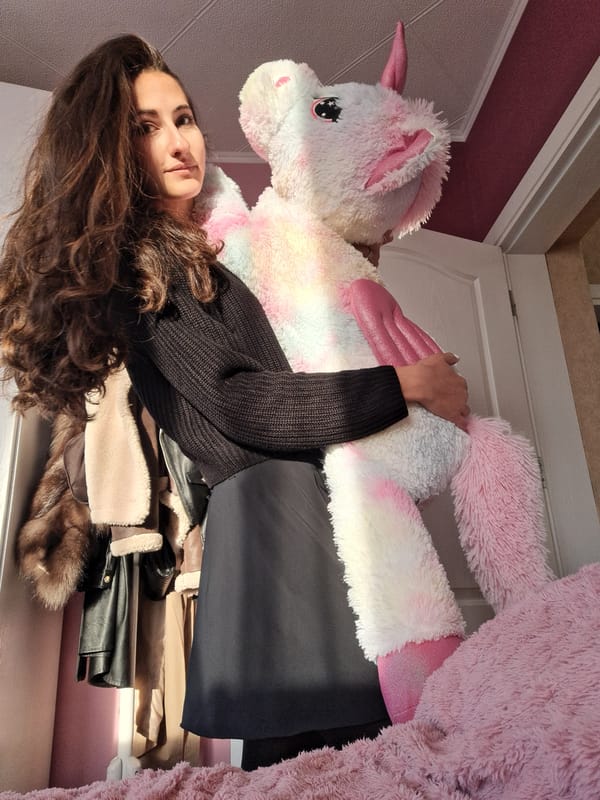 Woman photographed with plush unicorn toy in Chepintsi, Bulgaria