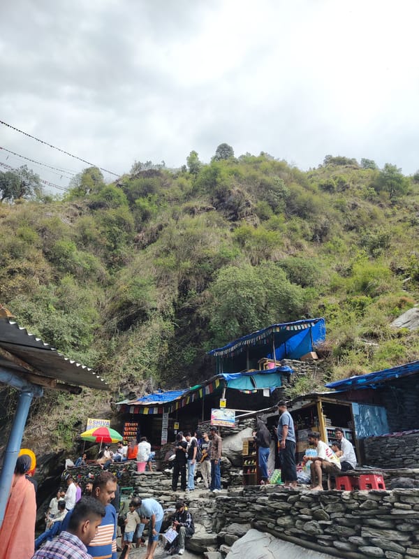 Mountain stream flows through rocky landscape in Bhagsu, India