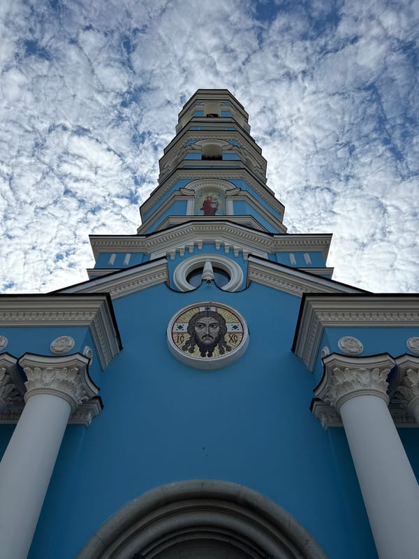 Orthodox church with blue architecture and golden domes photographed