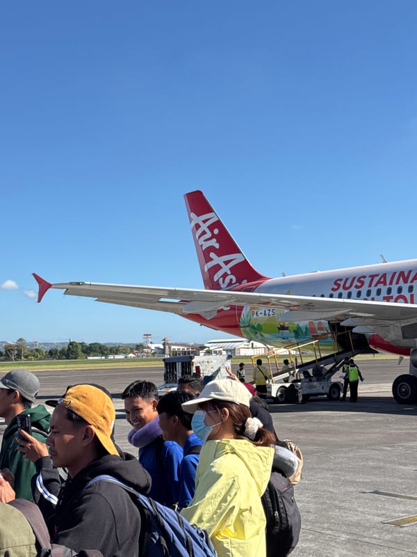 Boarding time at Bali airport, AirAsia sustainable tourism livery on display