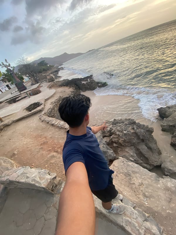 Person observes sunset from cliffs in Juan Griego, Venezuela