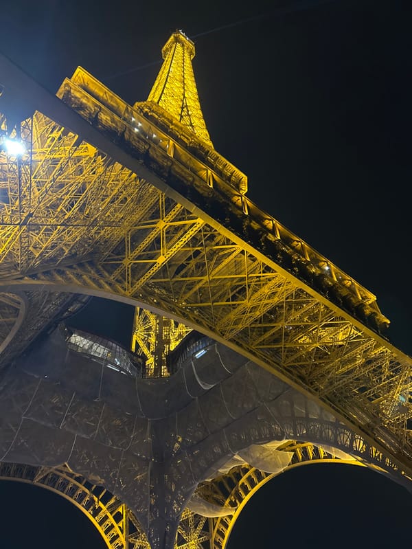 Eiffel Tower captured illuminated against dark Paris sky