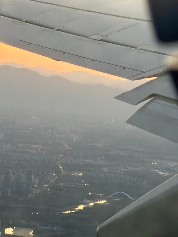 Passenger photographs airplane window view over Shunyi District