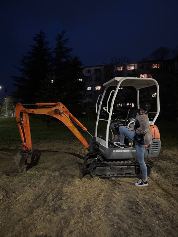 Woman poses on excavator at night in Varna