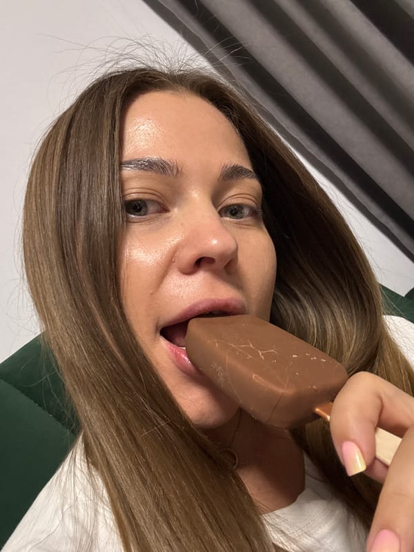Woman enjoys chocolate ice cream bar in Chernushka