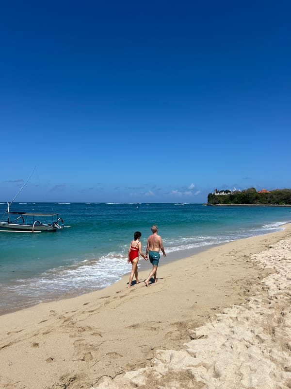 Busy beach day in Kuta Selatan with clear skies and calm seas