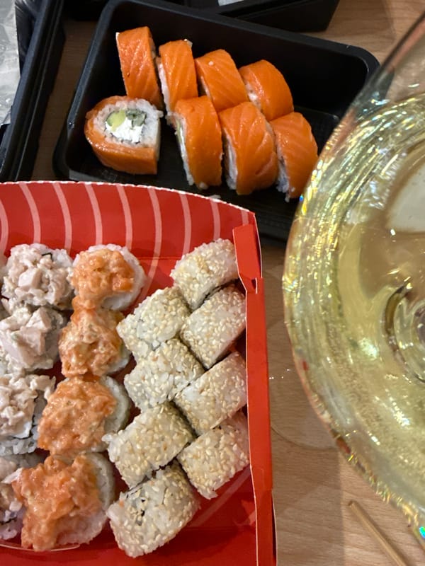 Sushi containers photographed on wooden table in Kazan