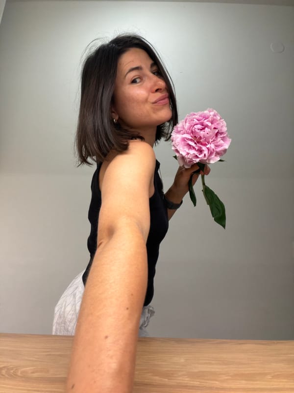 Woman poses with pink peony flower in Budva photo session