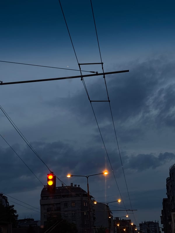Evening traffic scene documented in Belgrade under cloudy skies